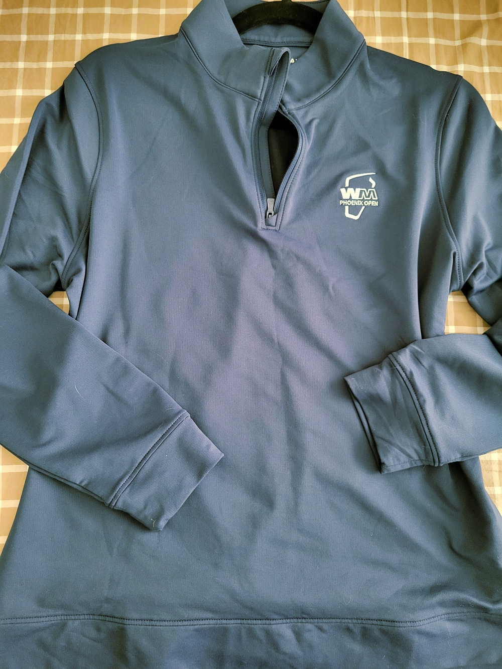 Peter Millar Golf Navy Blue Quarter-Zip Pullover Top with White Bucket Hat.